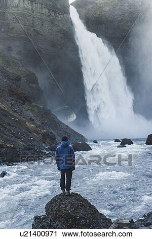 Stock Image - Hiker by Haifoss waterfall in Iceland. Fotosearch