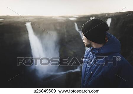 Stock Photo - Hiker by Haifoss waterfall in Iceland. Fotosearch