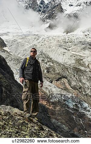 Stock Image - Hiker enjoying walk, Saas-Fee, Valais, Switzerland. Fotosearch