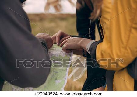 Picture - Hiking couple looking at map. Fotosearch