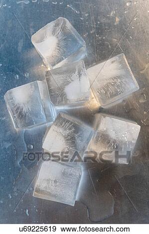 Ice cubes on silver surface View Large Photo Image Stock Photo - Ice cubes on silver surface. Fotosearch