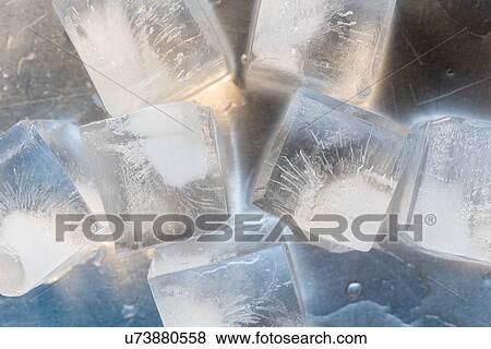 Stock Photo - Ice cubes on silver surface. Fotosearch