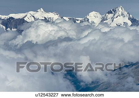 Layer of clouds near top of mountain range, Saas-Fee, Valais, Switzerland View Large Photo Image Stock Photo - Layer of clouds near top of mountain range, Saas-Fee, Valais, Switzerland. Fotosearch