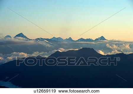 Layer of clouds near top of mountain range, Saas-Fee, Valais, Switzerland View Large Photo Image Stock Photo - Layer of clouds near top of mountain range, Saas-Fee, Valais, Switzerland. Fotosearch
