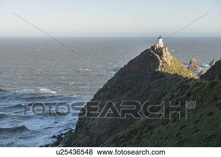 Stock Photo - Lighthouse on Nugget Point in Otago, New Zealand. Fotosearch