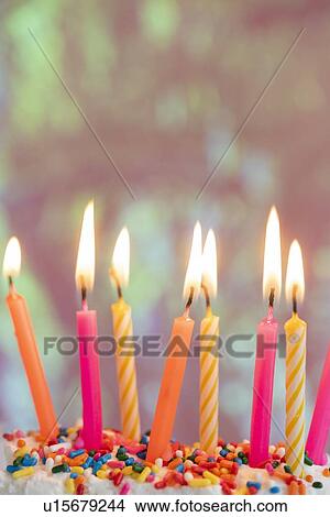 Lit candles on birthday cake View Large Photo Image Picture - Lit candles on birthday cake. Fotosearch