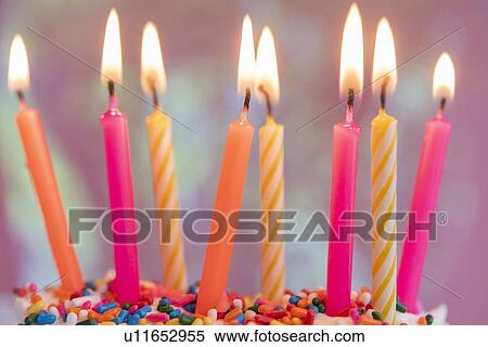 Lit candles on birthday cake View Large Photo Image Stock Photography - Lit candles on birthday cake. Fotosearch