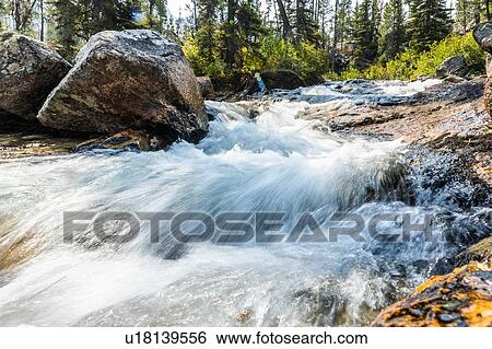 Stock Photograph - Long exposure of flowing stream in Stanley, Idaho. Fotosearch