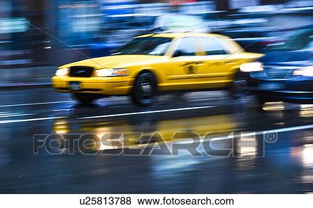 Stock Photo - Long exposure of taxi in New York City, USA. Fotosearch