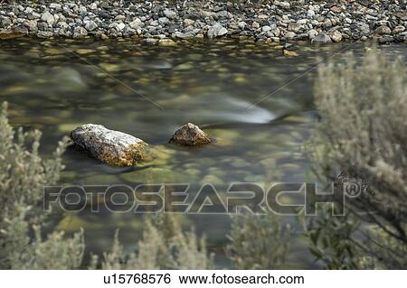 Long exposure shot of rocks in river View Large Photo Image Stock Photograph - Long exposure shot of rocks in river. Fotosearch