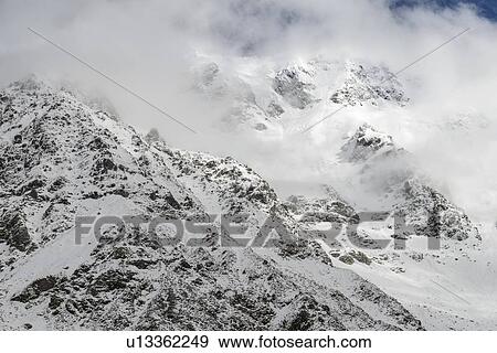 Stock Photo - Low cloud over mountains in Mount Cook National Park, New Zealand. Fotosearch