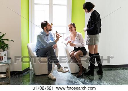 Male and female business creatives looking at smartphone in office View Large Photo Image Stock Image - Male and female business creatives looking at smartphone in office. Fotosearch