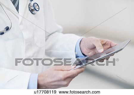 Male doctor using digital tablet. View Large Photo Image Stock Photo - Male doctor using digital tablet.. Fotosearch