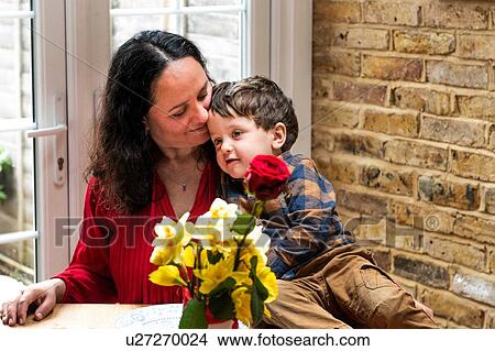 Picture - Male toddler leaning against mother's shoulder celebrating mothers day. Fotosearch