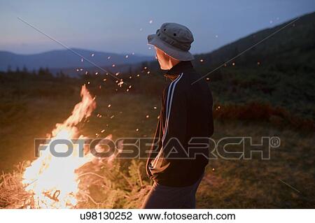 Man by campfire View Large Photo Image Stock Image - Man by campfire. Fotosearch