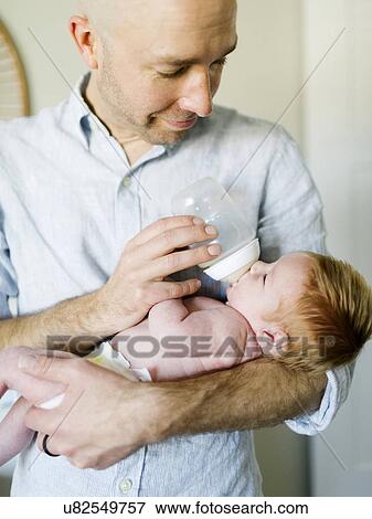 Man feeding his baby son View Large Photo Image Stock Photo - Man feeding his baby son. Fotosearch