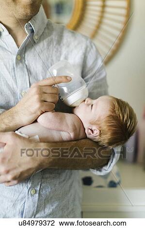 Man feeding his newborn son View Large Photo Image Stock Image - Man feeding his newborn son. Fotosearch