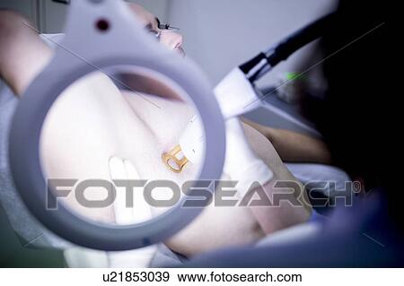Man getting laser hair removal treatment for under arms with magnifying glass in foreground. View Large Photo Image Stock Photo - Man getting laser hair removal treatment for under arms with magnifying glass in foreground.. Fotosearch