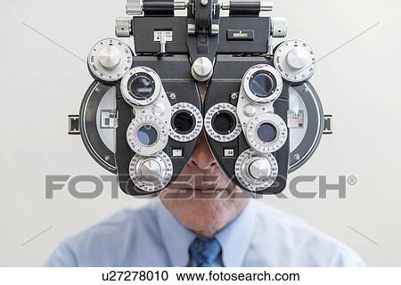 Stock Image - Man having his eyes tested.. Fotosearch