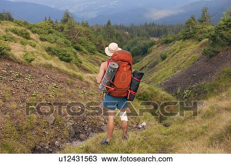 Stock Image - Man hiking in the Carpathian Mountain Range. Fotosearch