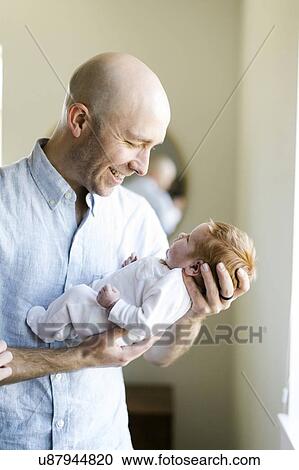Man holding his baby son View Large Photo Image Stock Image - Man holding his baby son. Fotosearch