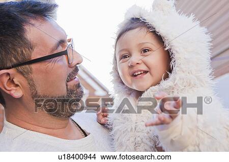 Picture - Man holding smiling daughter. Fotosearch