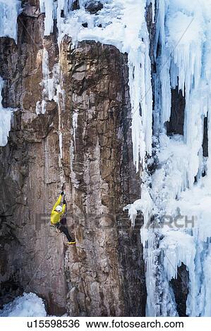 Stock Photograph - Man ice climbing in Ouray, USA. Fotosearch