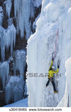 Stock Photography - Man ice climbing in Ouray, USA. Fotosearch