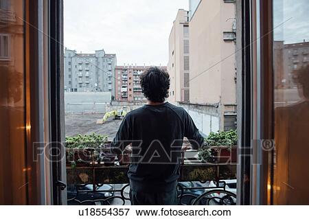 Man in deep thought on balcony View Large Photo Image Stock Photo - Man in deep thought on balcony. Fotosearch