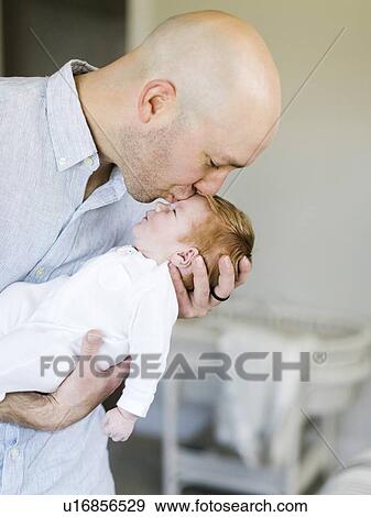 Stock Photo - Man kissing his baby son. Fotosearch