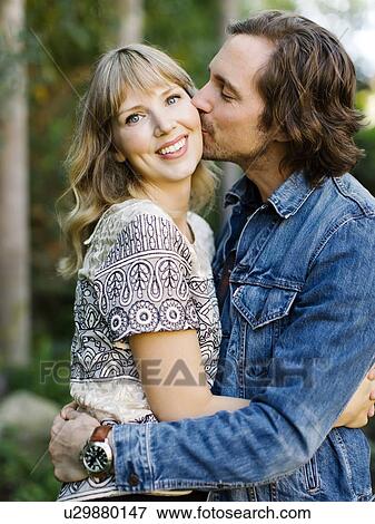 Man kissing woman's cheek View Large Photo Image Stock Photo - Man kissing woman's cheek. Fotosearch