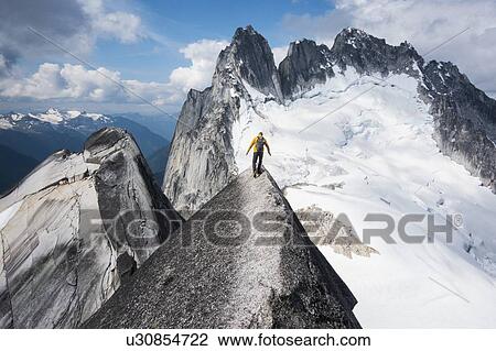 Stock Image - Man mountain climbing in Bugaboo Provincial Park, British Columbia, Canada. Fotosearch