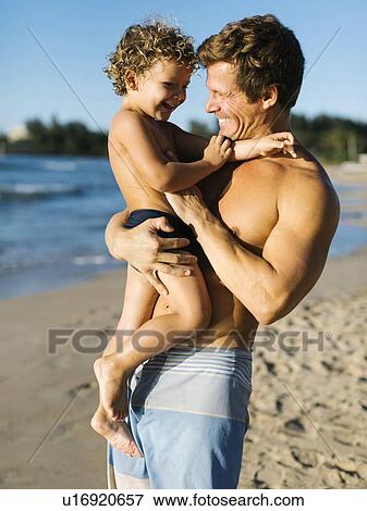 Man playing with his son on beach View Large Photo Image Stock Photo - Man playing with his son on beach. Fotosearch