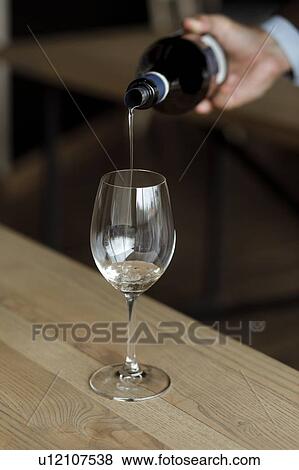 Man pouring bottle of wine View Large Photo Image Stock Photo - Man pouring bottle of wine. Fotosearch