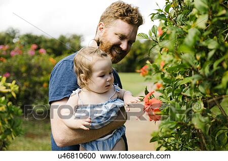 Man showing baby daughter flowers View Large Photo Image Stock Image - Man showing baby daughter flowers. Fotosearch