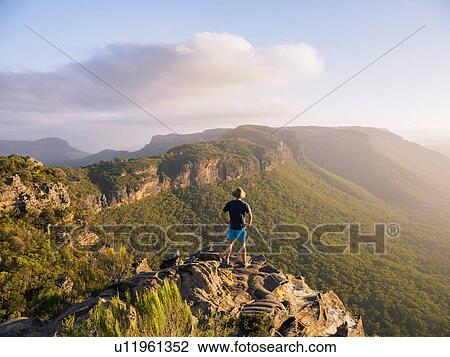 Man standing on peak of Blue Mountains in New South Wales, Australia View Large Photo Image Stock Image - Man standing on peak of Blue Mountains in New South Wales, Australia. Fotosearch