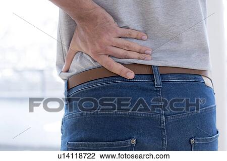 Man touching his back in pain. View Large Photo Image Stock Image - Man touching his back in pain.. Fotosearch