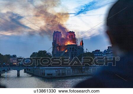 Man watching Notre-Dame de Paris fire from far, Paris, Ile-de-France, France View Large Photo Image Stock Image - Man watching Notre-Dame de Paris fire from far, Paris, Ile-de-France, France. Fotosearch
