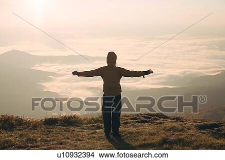 Man with arms outstretched in the Carpathian Mountain Range at sunrise View Large Photo Image Picture - Man with arms outstretched in the Carpathian Mountain Range at sunrise. Fotosearch