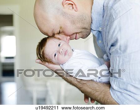 Man with his head to his baby son View Large Photo Image Stock Image - Man with his head to his baby son. Fotosearch