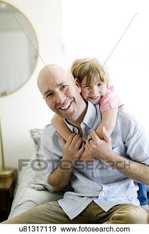 Man with his son on his back View Large Photo Image Stock Photo - Man with his son on his back. Fotosearch