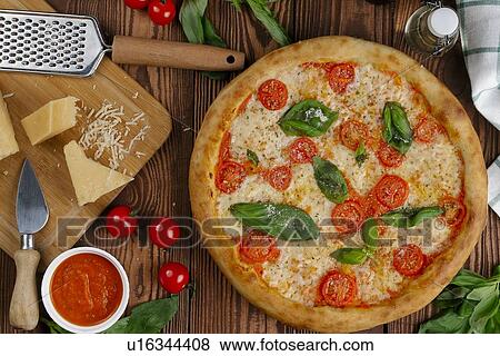Stock Photo - Margherita pizza with ingredients. Fotosearch