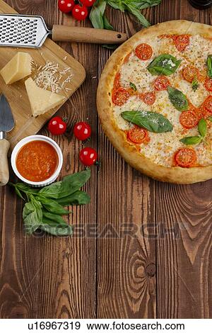 Stock Photo - Margherita pizza with ingredients. Fotosearch