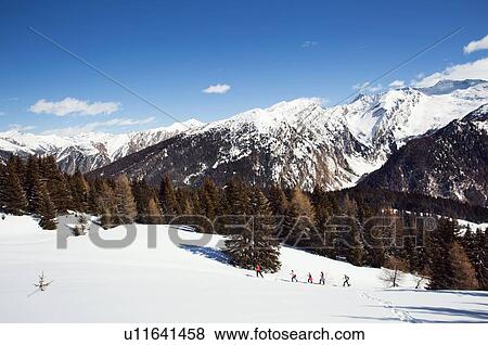 Mature couple and daughters snowshoeing in snow covered mountain landscape, distant view, Styria, Tyrol, Austria View Large Photo Image Stock Photo - Mature couple and daughters snowshoeing in snow covered mountain landscape, distant view, Styria, Tyrol, Austria. Fotosearch