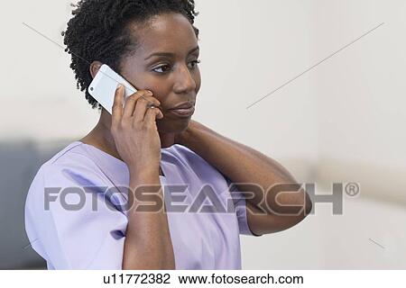 Mature female nurse on cell phone. View Large Photo Image Stock Image - Mature female nurse on cell phone.. Fotosearch