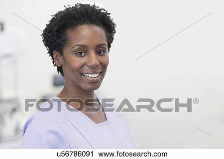 Mature female nurse smiling towards camera. View Large Photo Image Stock Image - Mature female nurse smiling towards camera.. Fotosearch