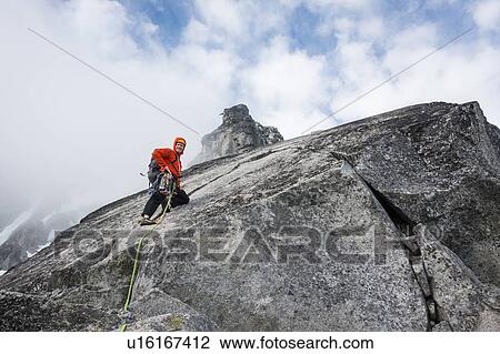 Stock Image - Mature man mountain climbing on Mount Stuart in North Cascade Mountains, Washington, USA. Fotosearch