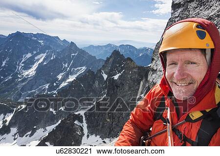 Stock Image - Mature man mountain climbing on Mount Stuart in North Cascade Mountains, Washington, USA. Fotosearch