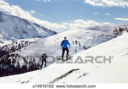 Mature skiing couple moving up snow covered mountain, Styria, Tyrol, Austria View Large Photo Image Stock Image - Mature skiing couple moving up snow covered mountain, Styria, Tyrol, Austria. Fotosearch