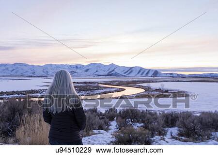 Mature woman by river during winter in Picabo, Idaho View Large Photo Image Stock Photo - Mature woman by river during winter in Picabo, Idaho. Fotosearch